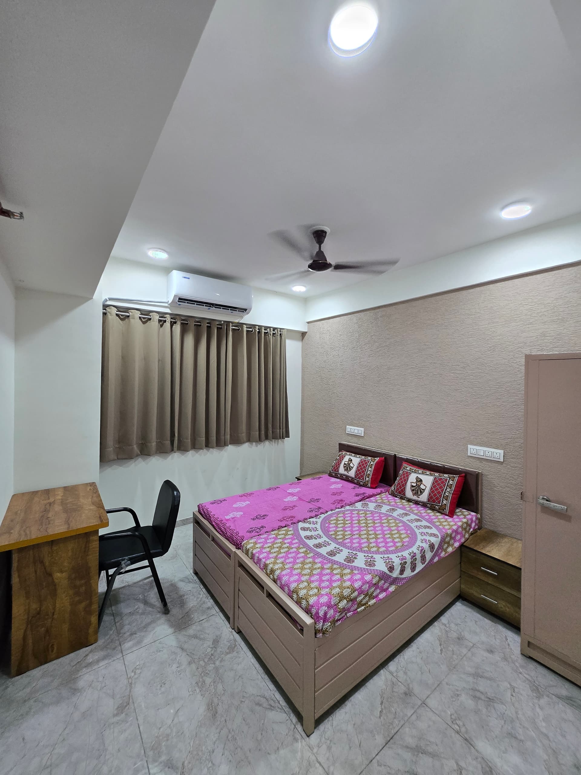 Single A.C. room interior with study desk at Mansarovar Girls PG, Ahmedabad